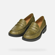 Pair of green loafers on a white background