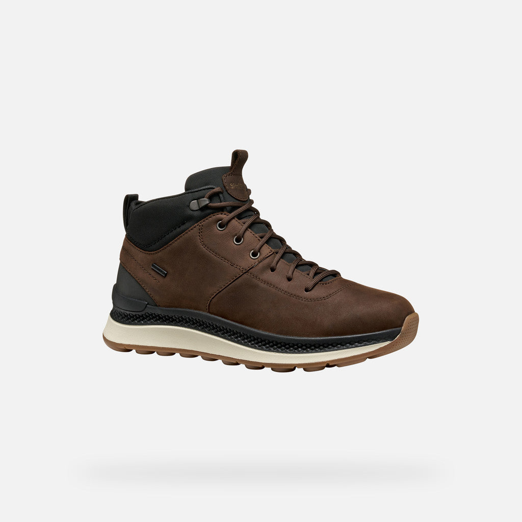 Brown leather boot with black accents on a white background