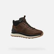 Brown leather boot with black accents on a white background