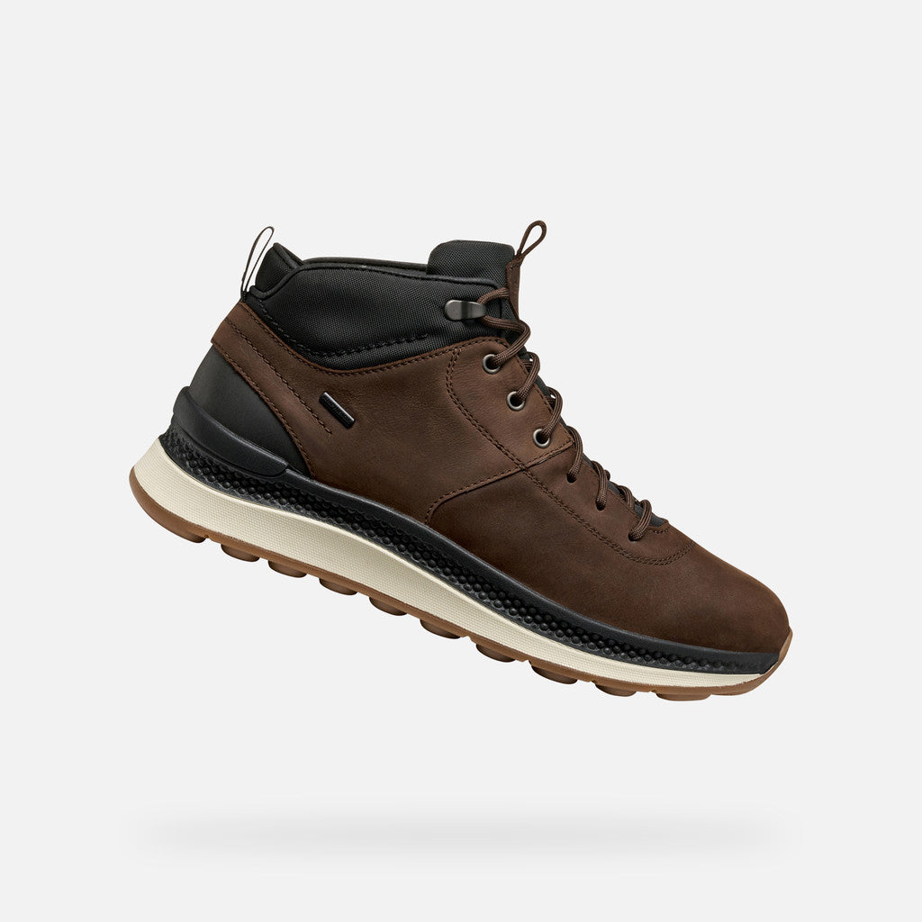 Brown leather boot with black accents on a white background
