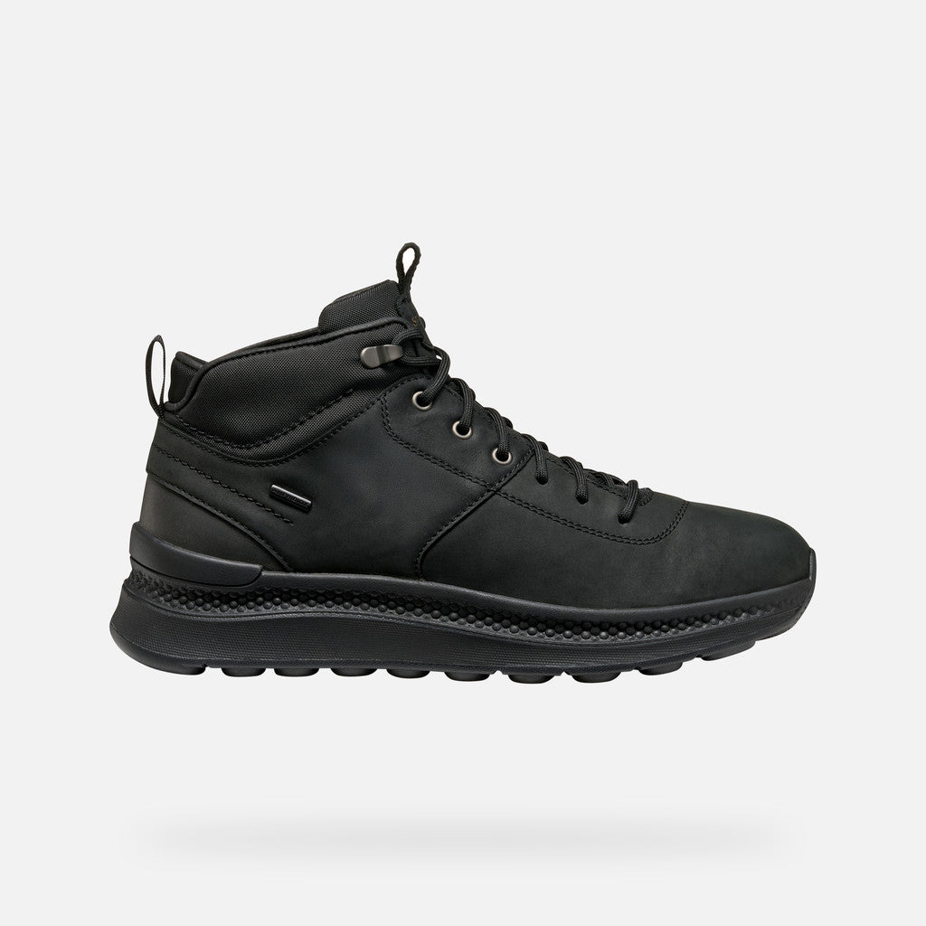 Black boot with black sole on a white background
