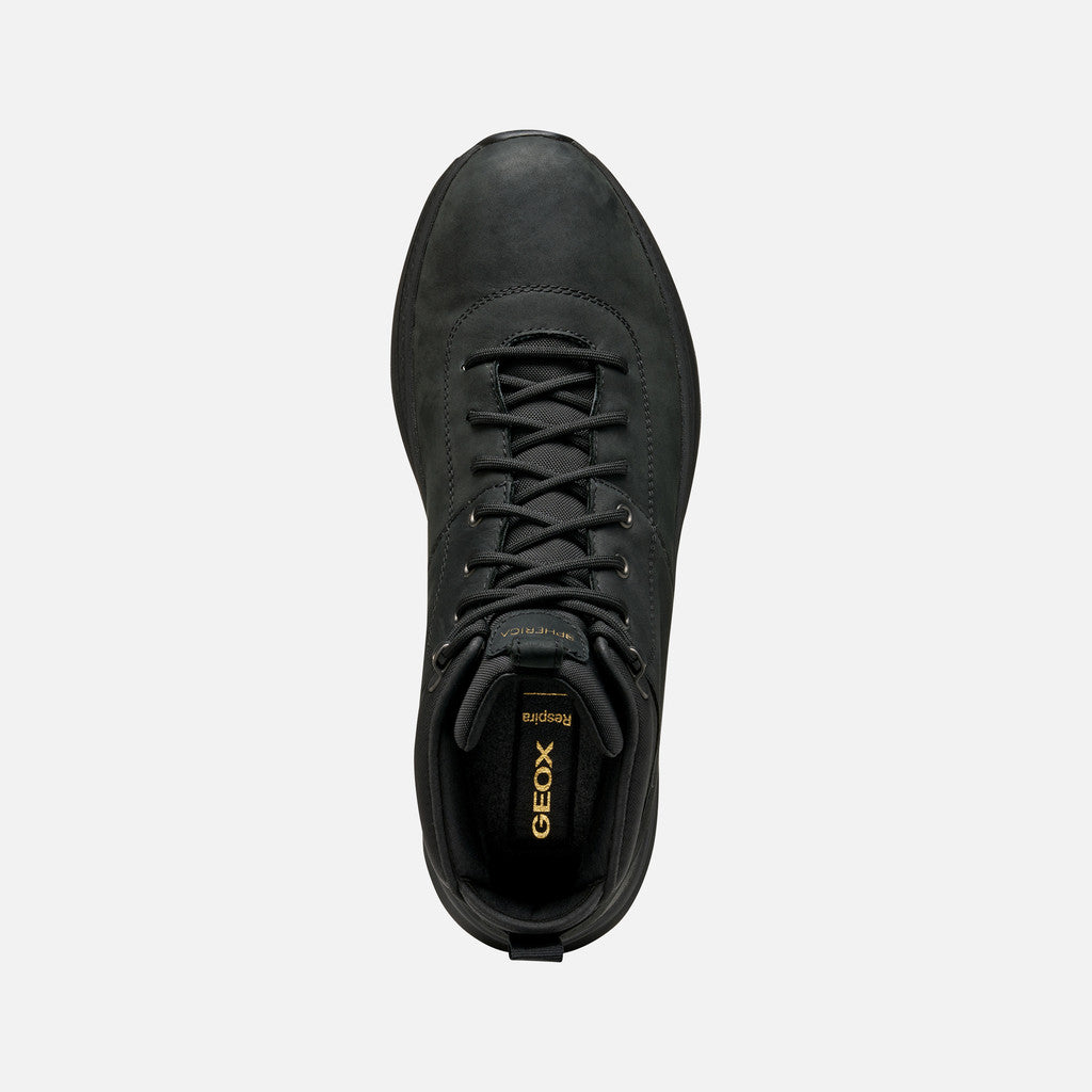 Black boot with laces on a white background