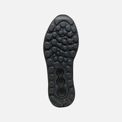 Close-up of a black shoe sole on a light gray background