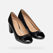 Pair of black high-heeled shoes on a light gray background
