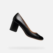 Black high-heeled shoe on a light gray background