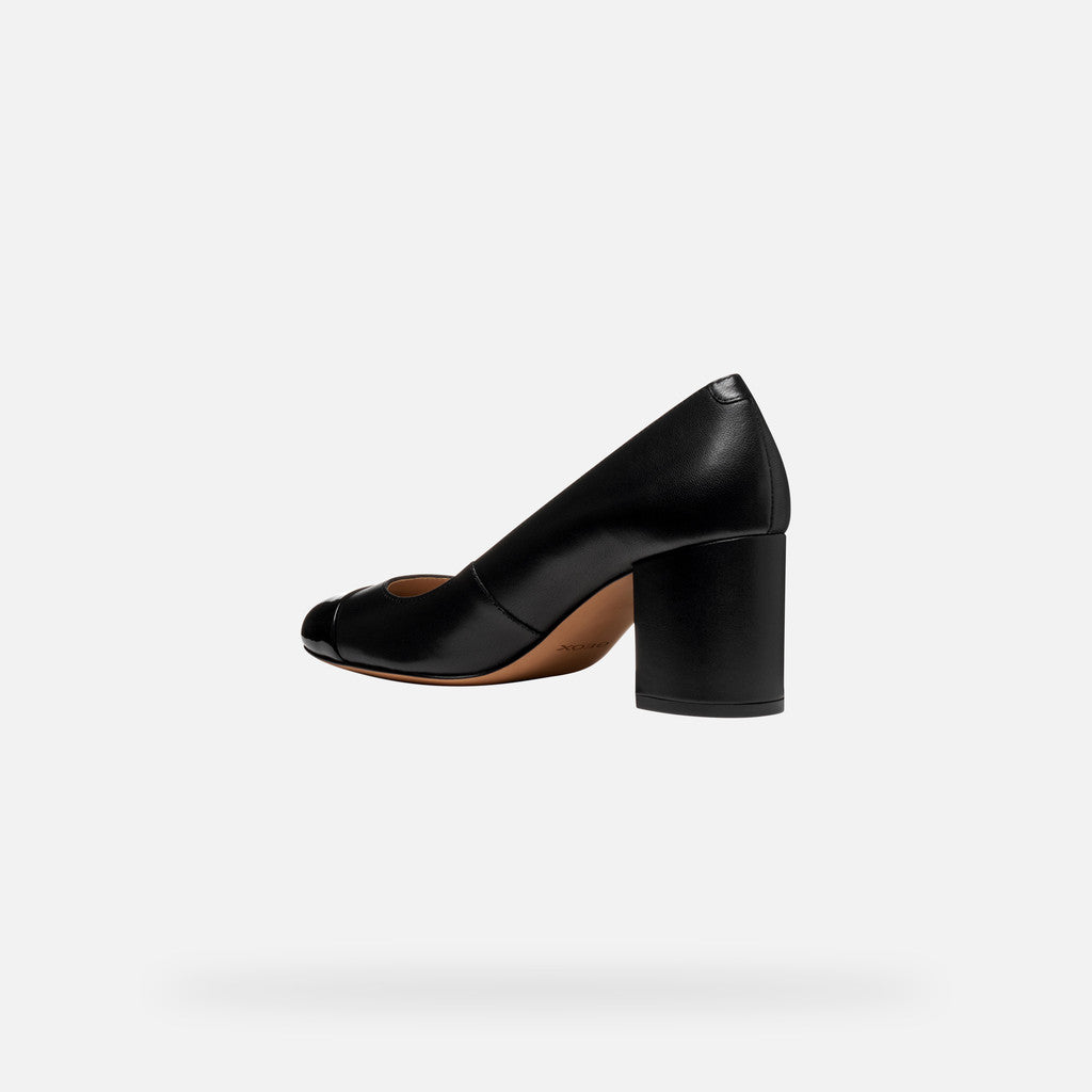 Black leather pump a white background