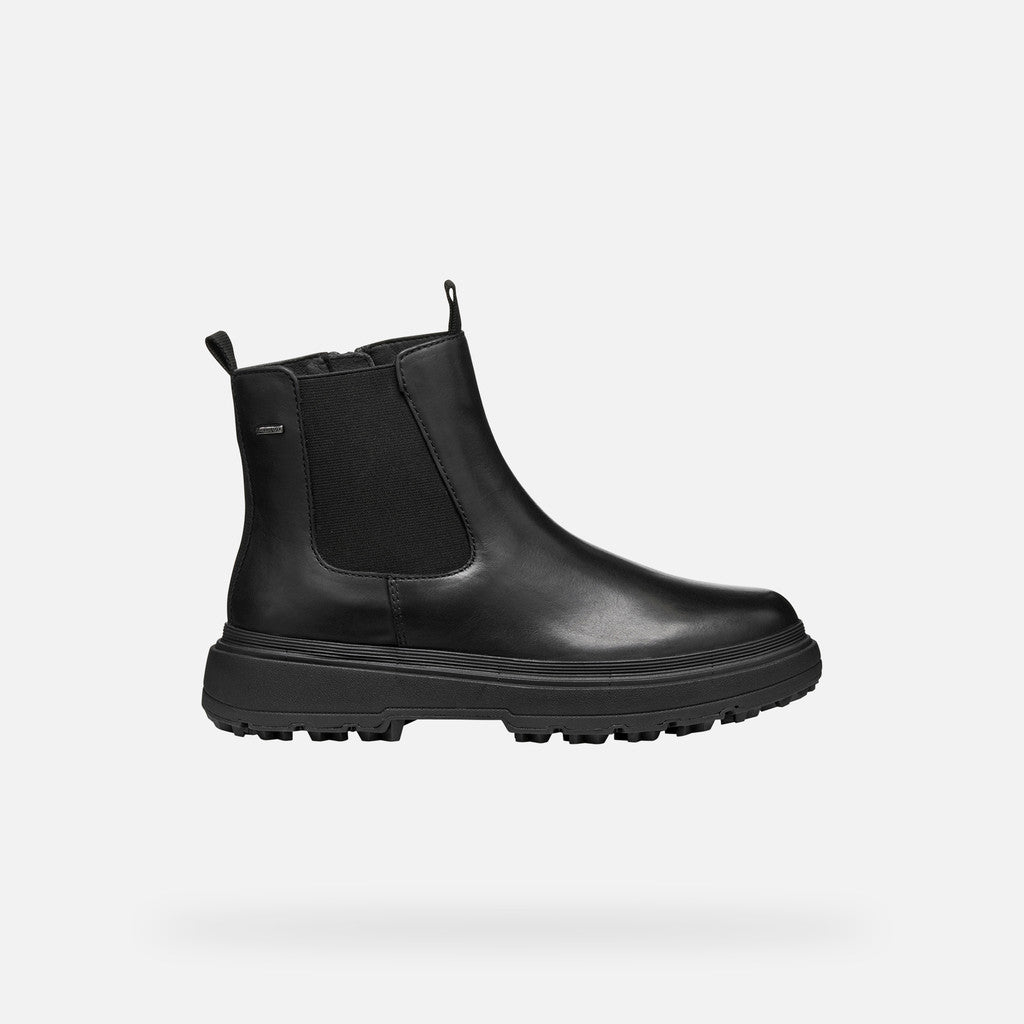 Black boot with a zipper on a white background