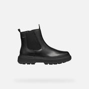 Black boot with a zipper on a white background
