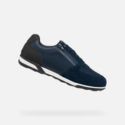 Navy blue sneaker with a white sole on a light gray background