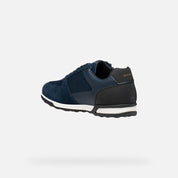 Navy blue sneaker with white sole on a light gray background