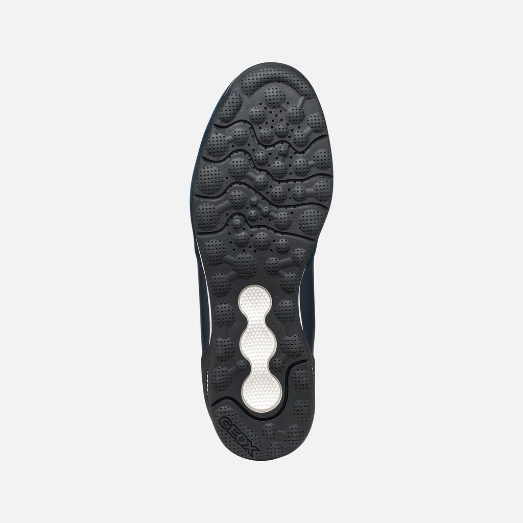Black shoe sole with a brand logo on a light gray background
