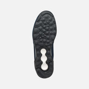 Black shoe sole with a brand logo on a light gray background