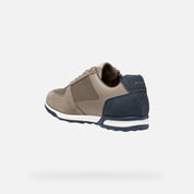 Two-tone sneaker with beige and navy design on a white background