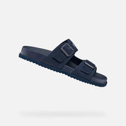 Navy blue sandal with two straps on a light gray background