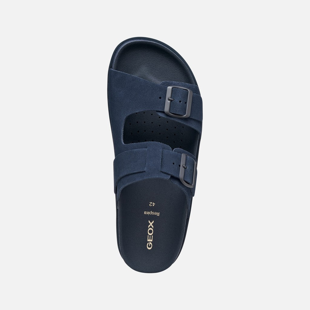Navy blue sandal with a buckle on a white background