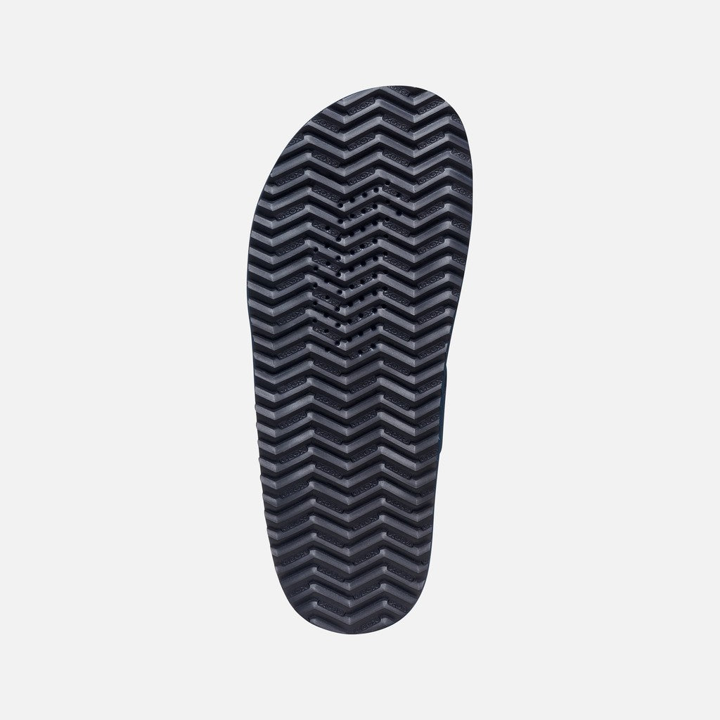 Black shoe sole with a zigzag pattern on a white background