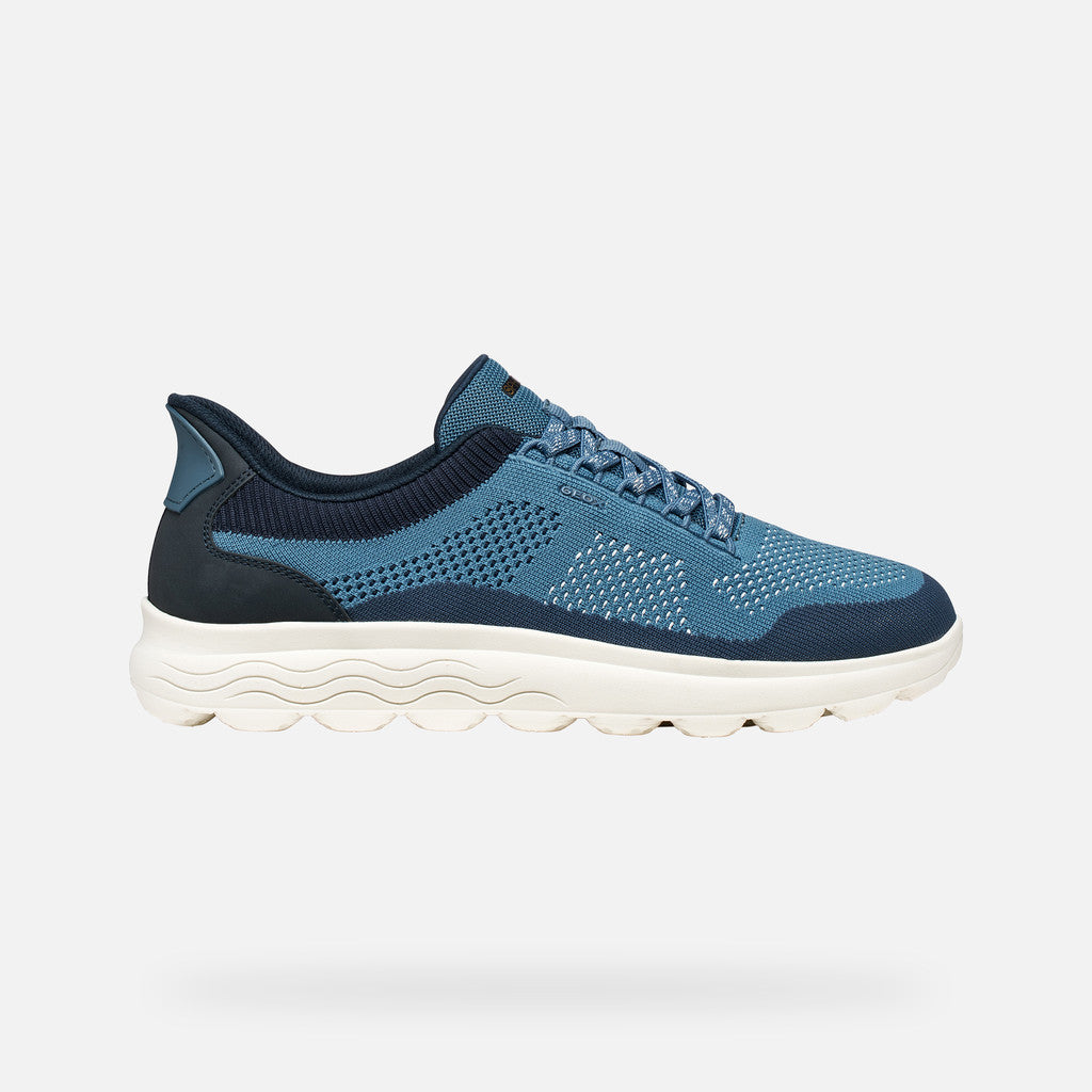 Blue athletic shoe on a light gray background