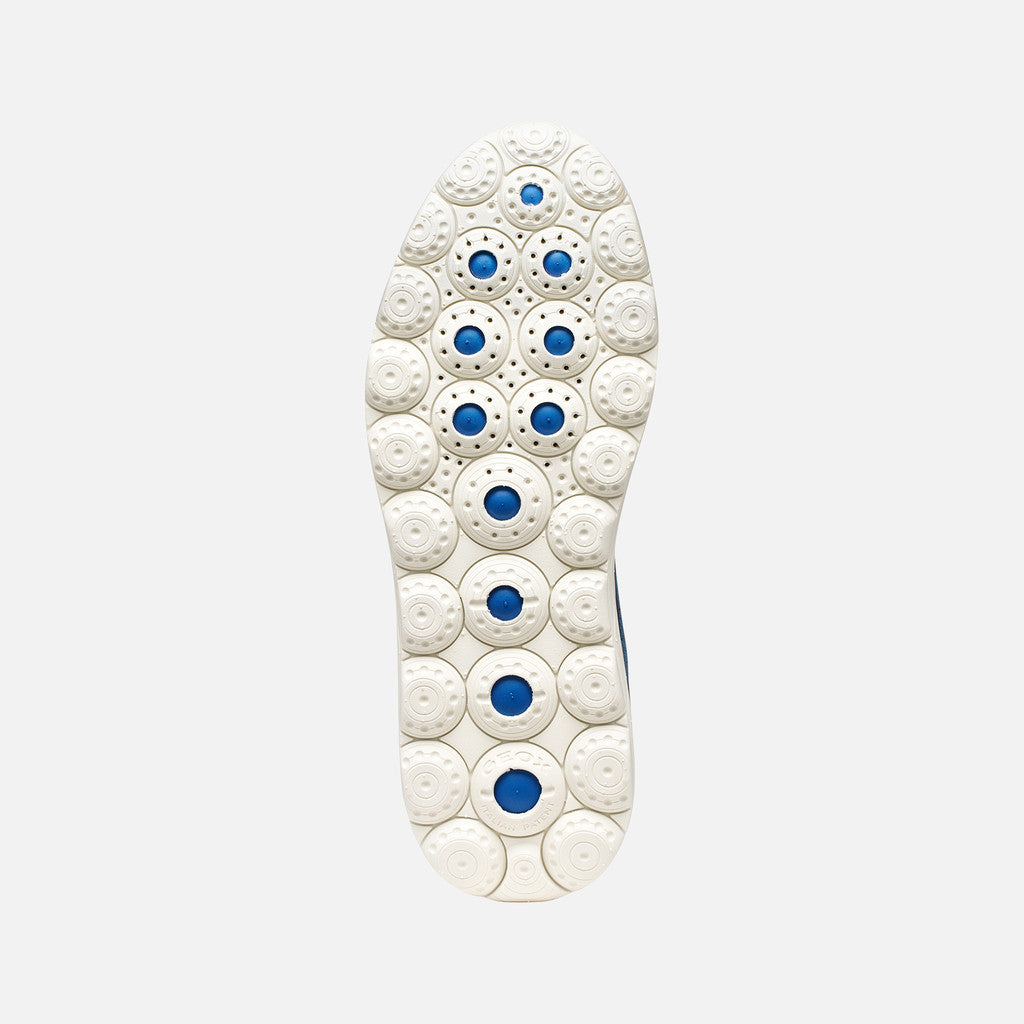 White shoe sole with blue accents on a light gray background