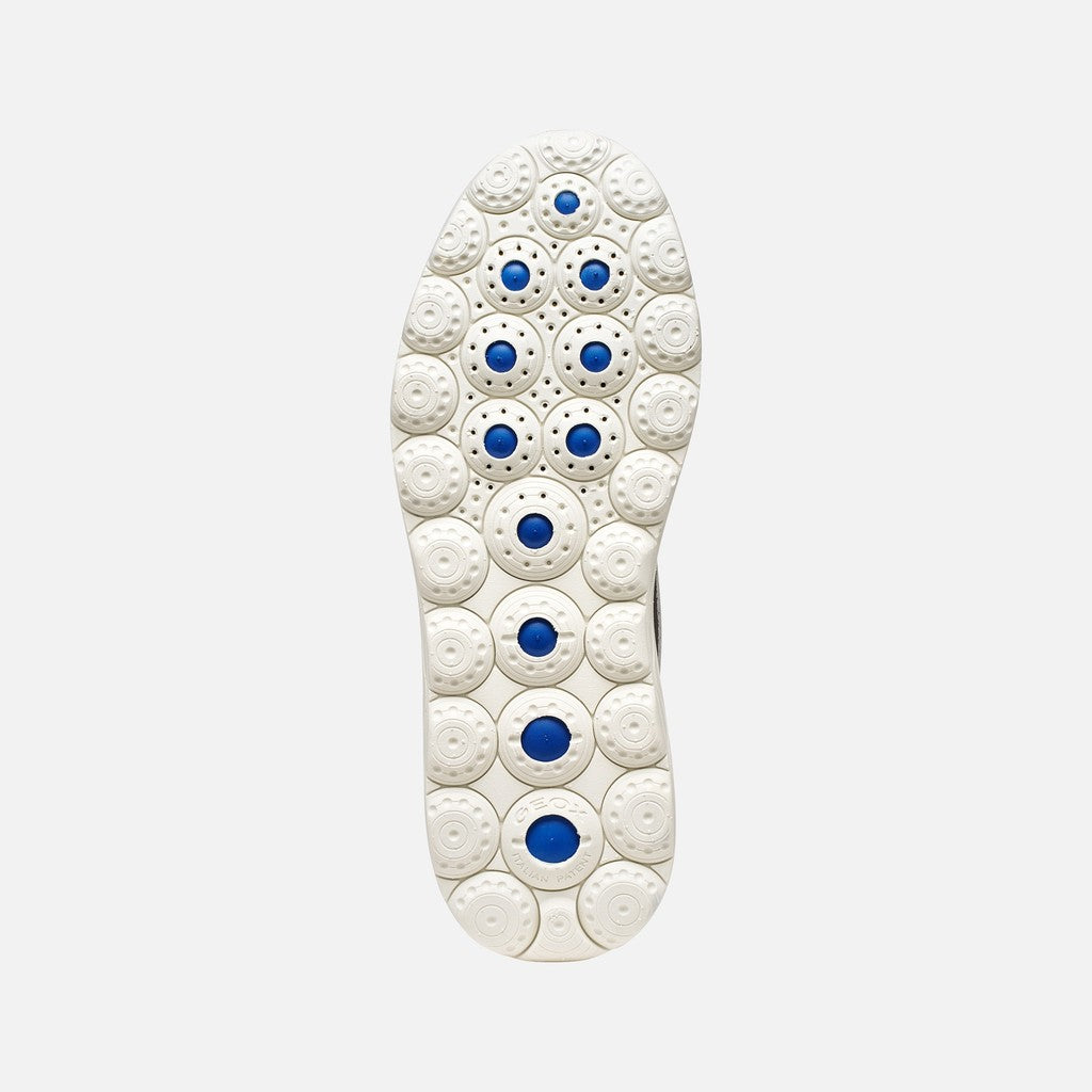 White shoe sole with blue accents on a light gray background