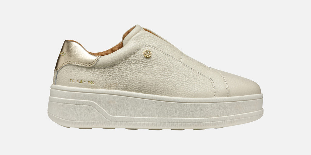 Beige sneaker with a platform sole on a white background