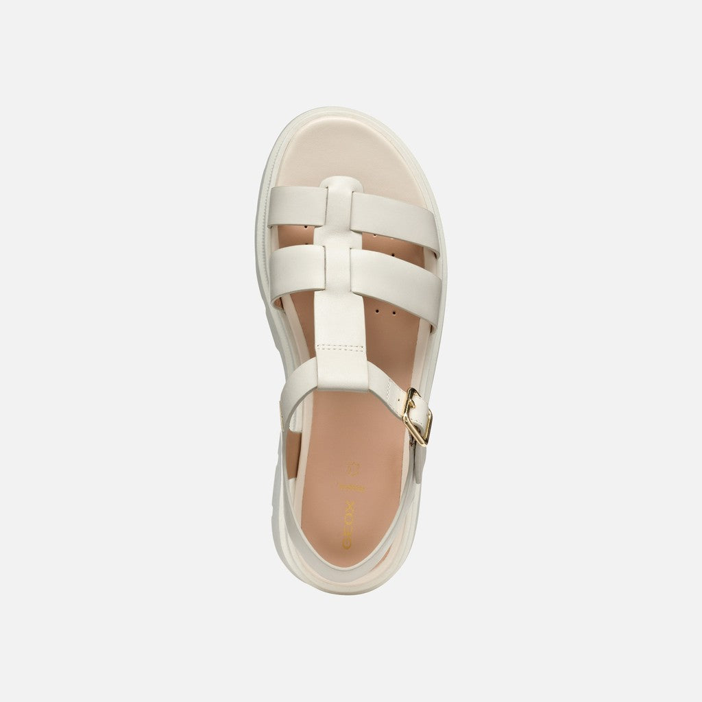 White sandal with multiple straps on a light gray background