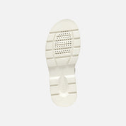 White sole of a shoe on a light gray background