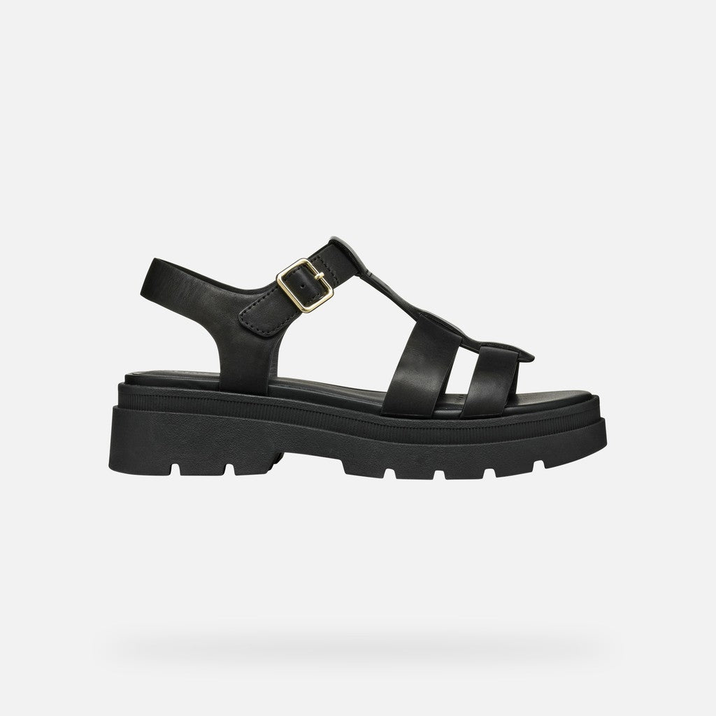 Black sandal with thick sole on a light gray background