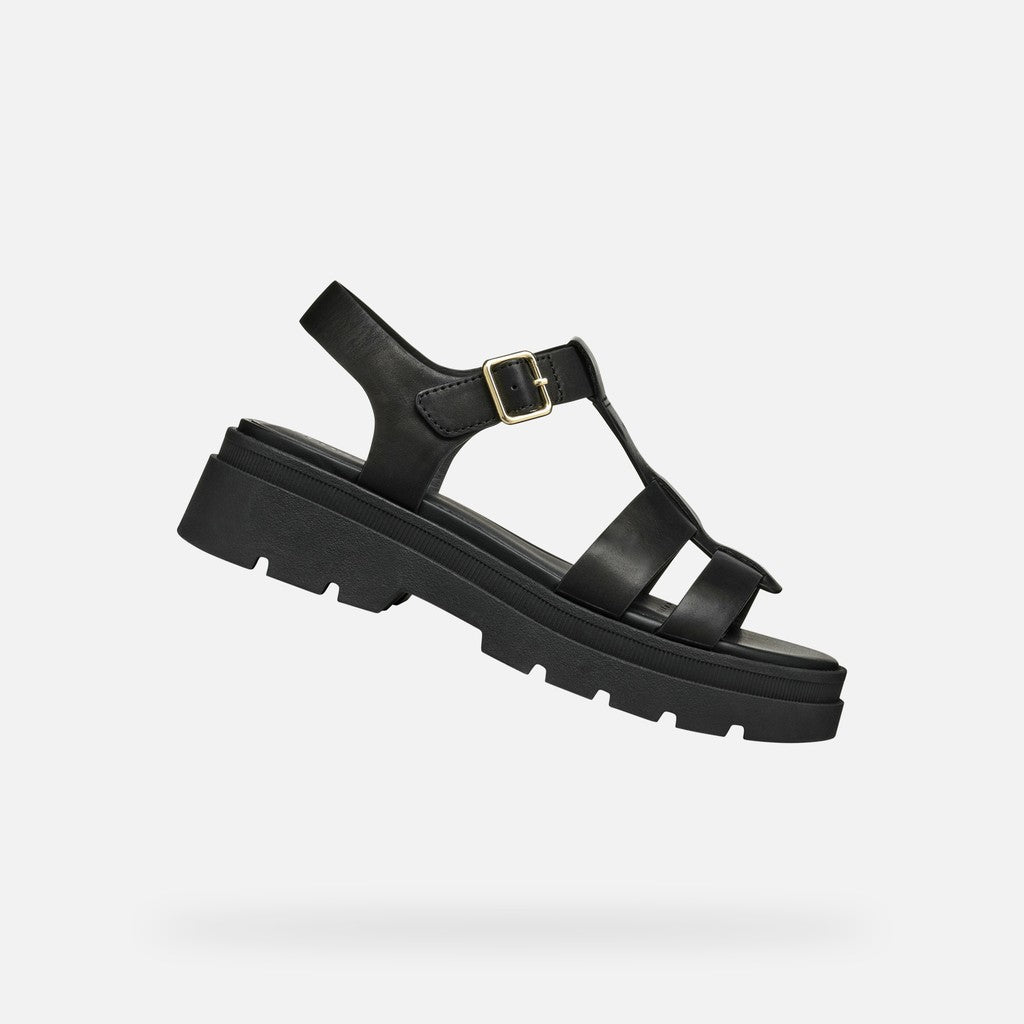 Black sandal with a thick sole on a white background