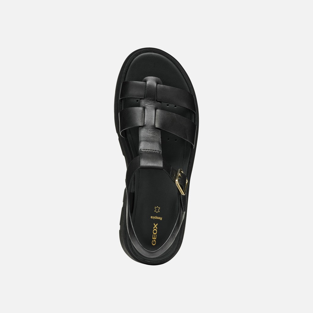 Black sandal with braided design on a white background