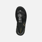 Black sandal with braided design on a white background