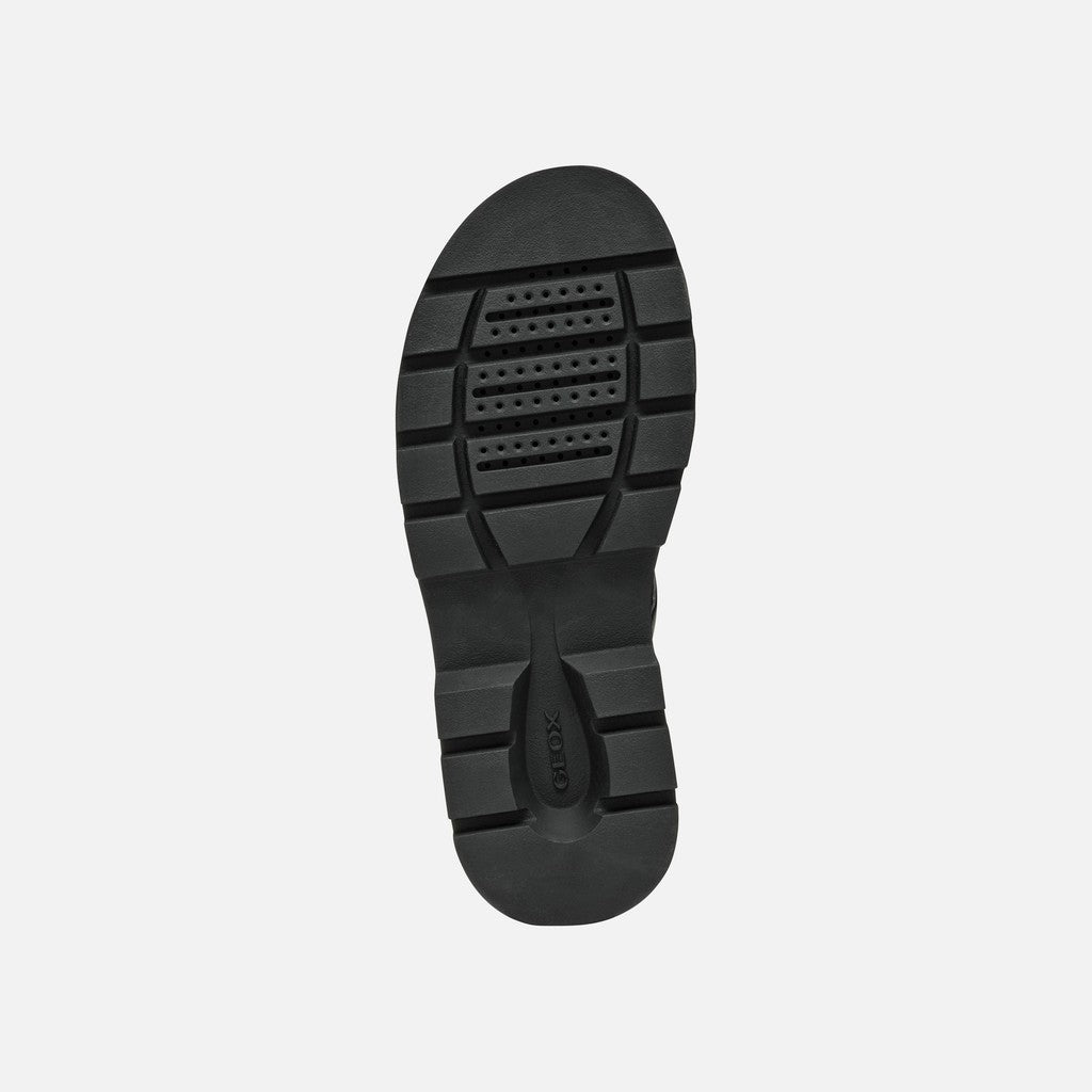 Black sandal sole on a light gray background