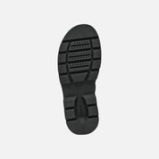 Black sandal sole on a light gray background