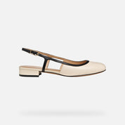 Cream sandal with black strap on a light gray background