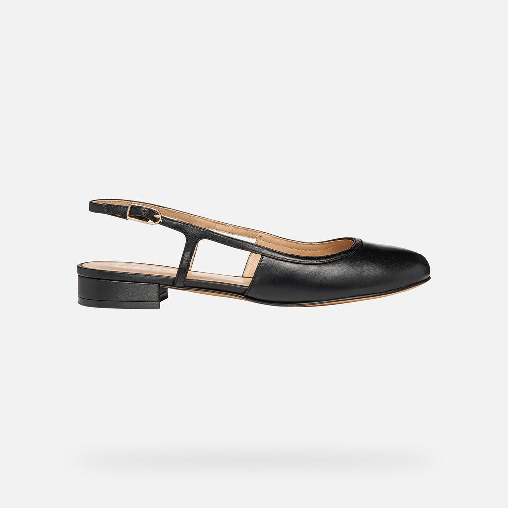 Black slingback flat shoe on a light gray background