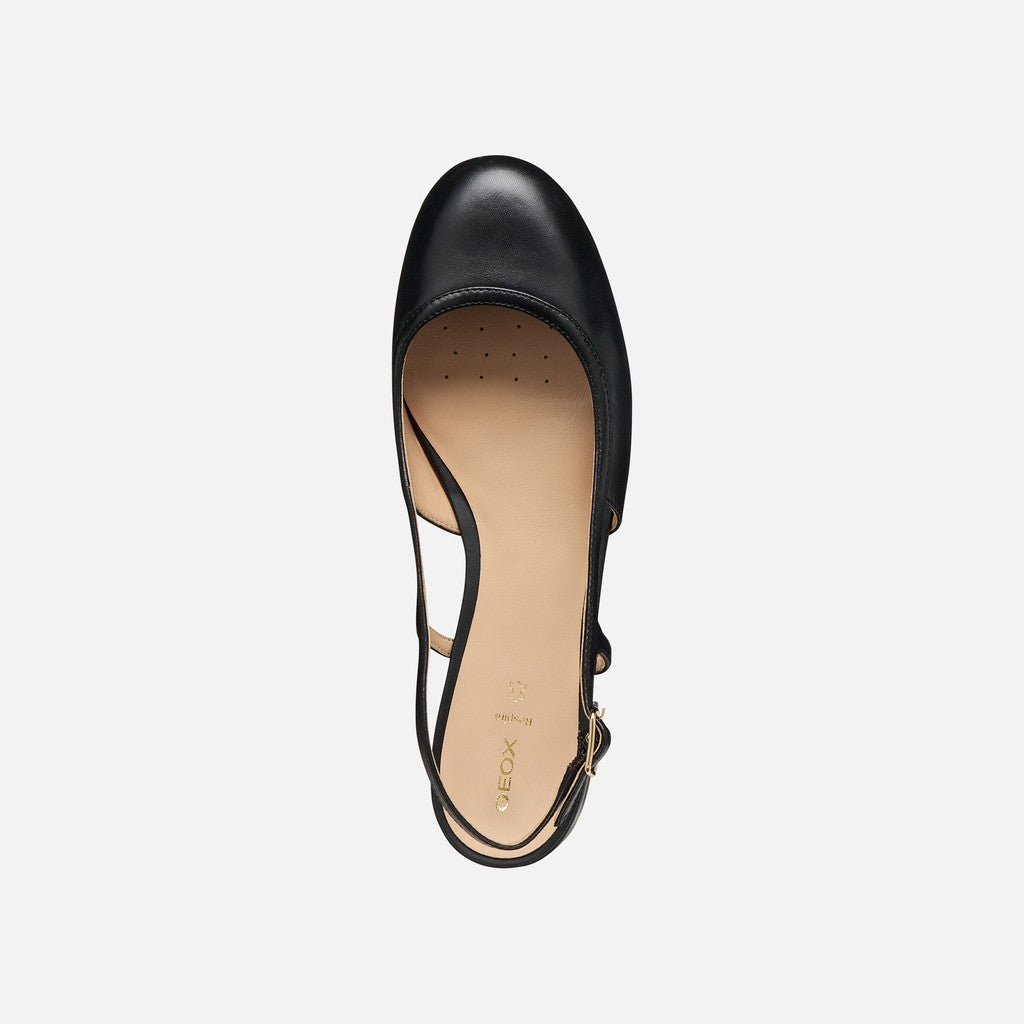 Black sandal with a slingback design on a light gray background