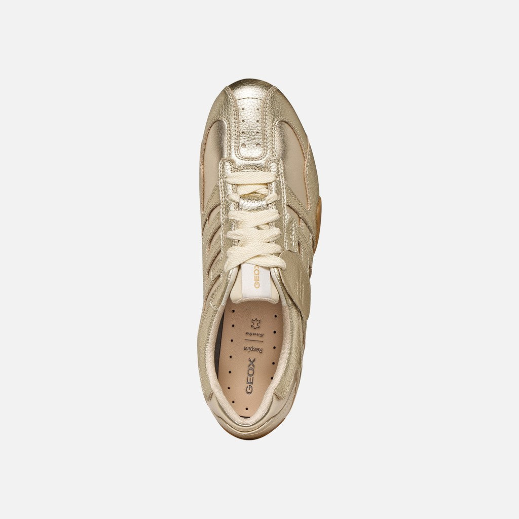 Gold sneaker on a white background