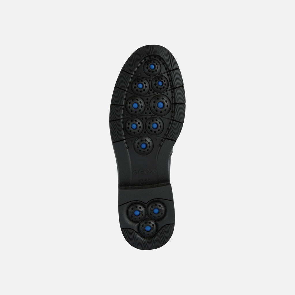 Black shoe sole with blue accents on a white background