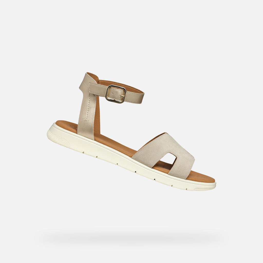 Beige sandal with a strap and buckle on a white background