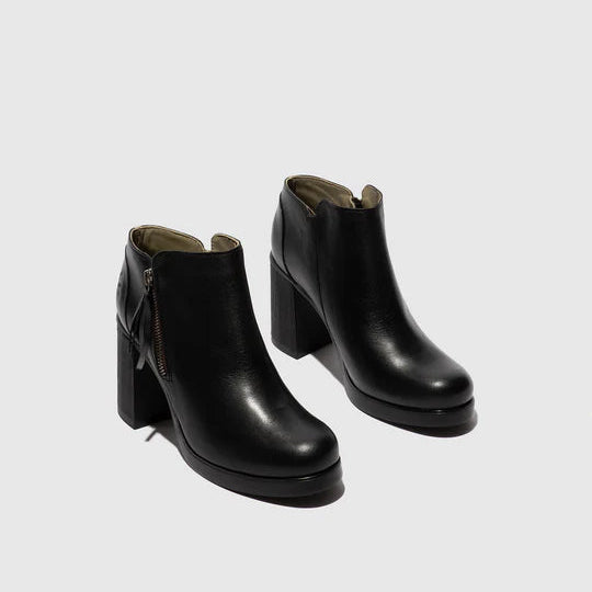 Pair of black ankle boots on a light gray background