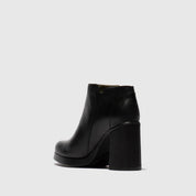 Black ankle boot on a light gray background
