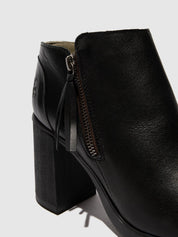 Black leather ankle boot with a block heel on a light gray background