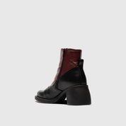 Black and red ankle boot on a light gray background
