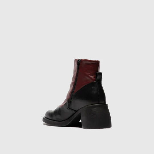 Black and red ankle boot on a light gray background