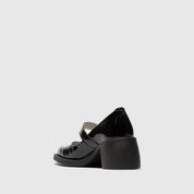 Black mary jane shoe on a light gray background