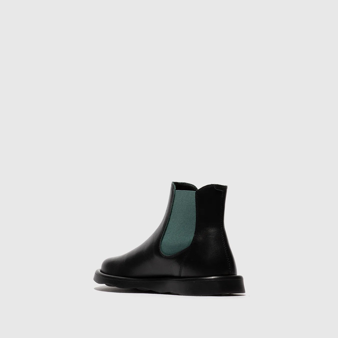 Black Chelsea boot with green lining on a light gray background