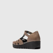 Taupe sandal with a wedge sole on a light gray background