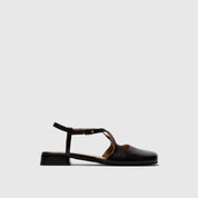 Black slingback with a thin strap on a light gray background