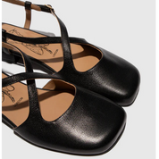 Pair of black leather slingback with thin straps on a light gray background