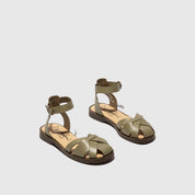 Pair of green sandals on a light gray background