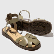 Pair of green sandals on a light gray background